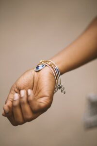 Close-up of an adult woman's hand adorned with stylish bracelets highlighting elegance.