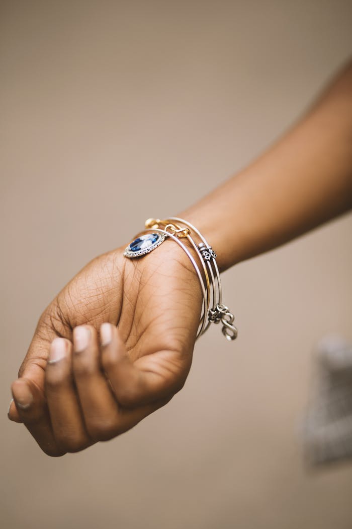 Close-up of an adult woman's hand adorned with stylish bracelets highlighting elegance.